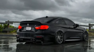 Rear of a Black BMW M4 on Wet Tarmac HD Wallpaper