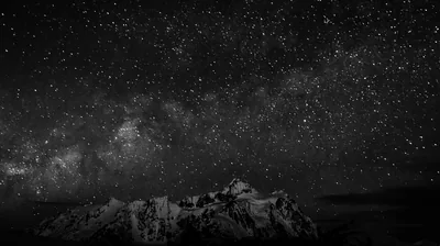 Rocky Peaks Under a Monochrome Milky Way HD Wallpaper