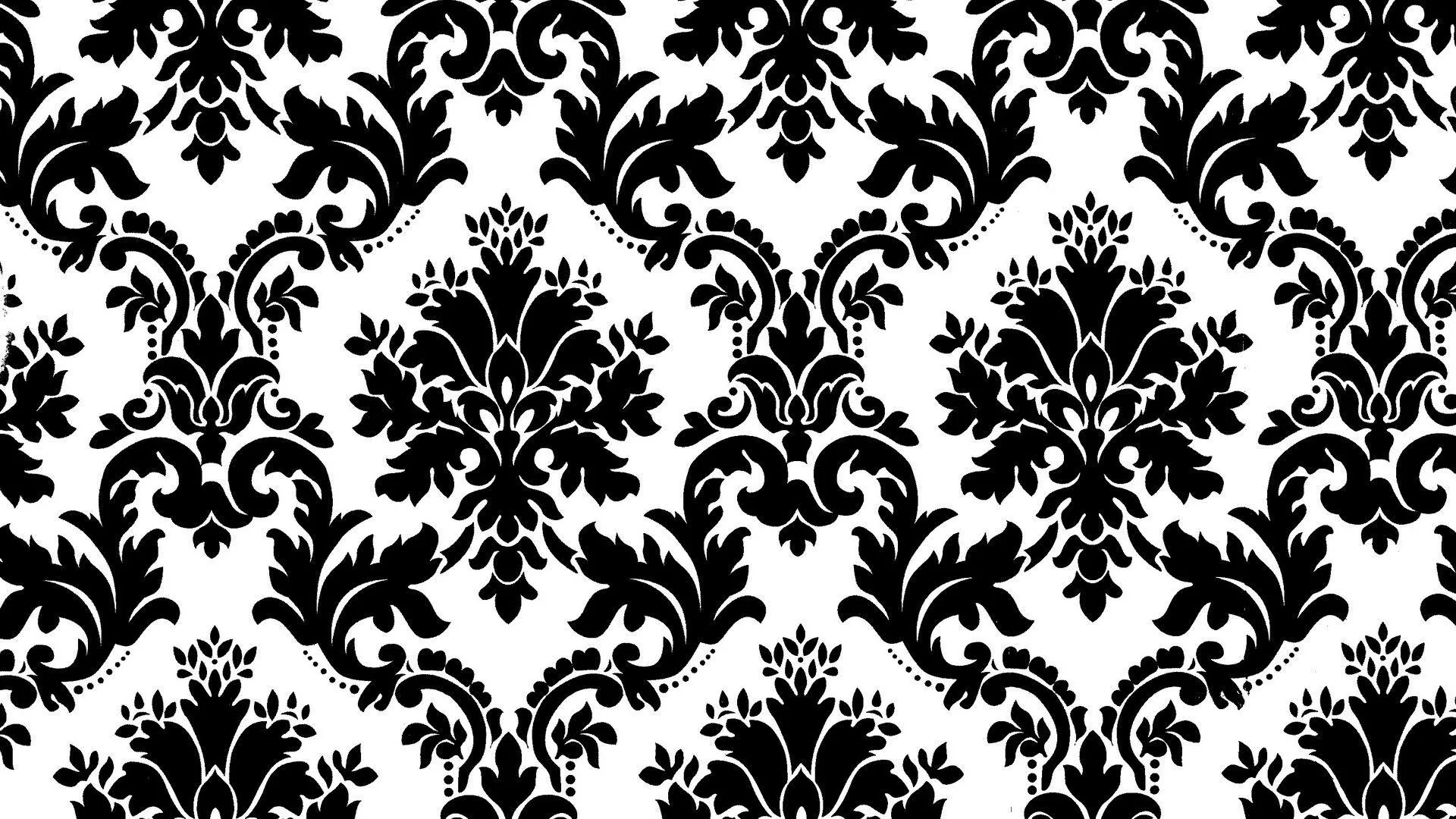 Large baroque flourishes stamped in solid black on white repeat across the frame with no shading, the way a classic wallpaper roll prints.