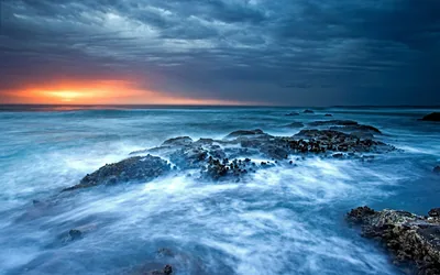 Misty Surf Under Storm Clouds HD Wallpaper