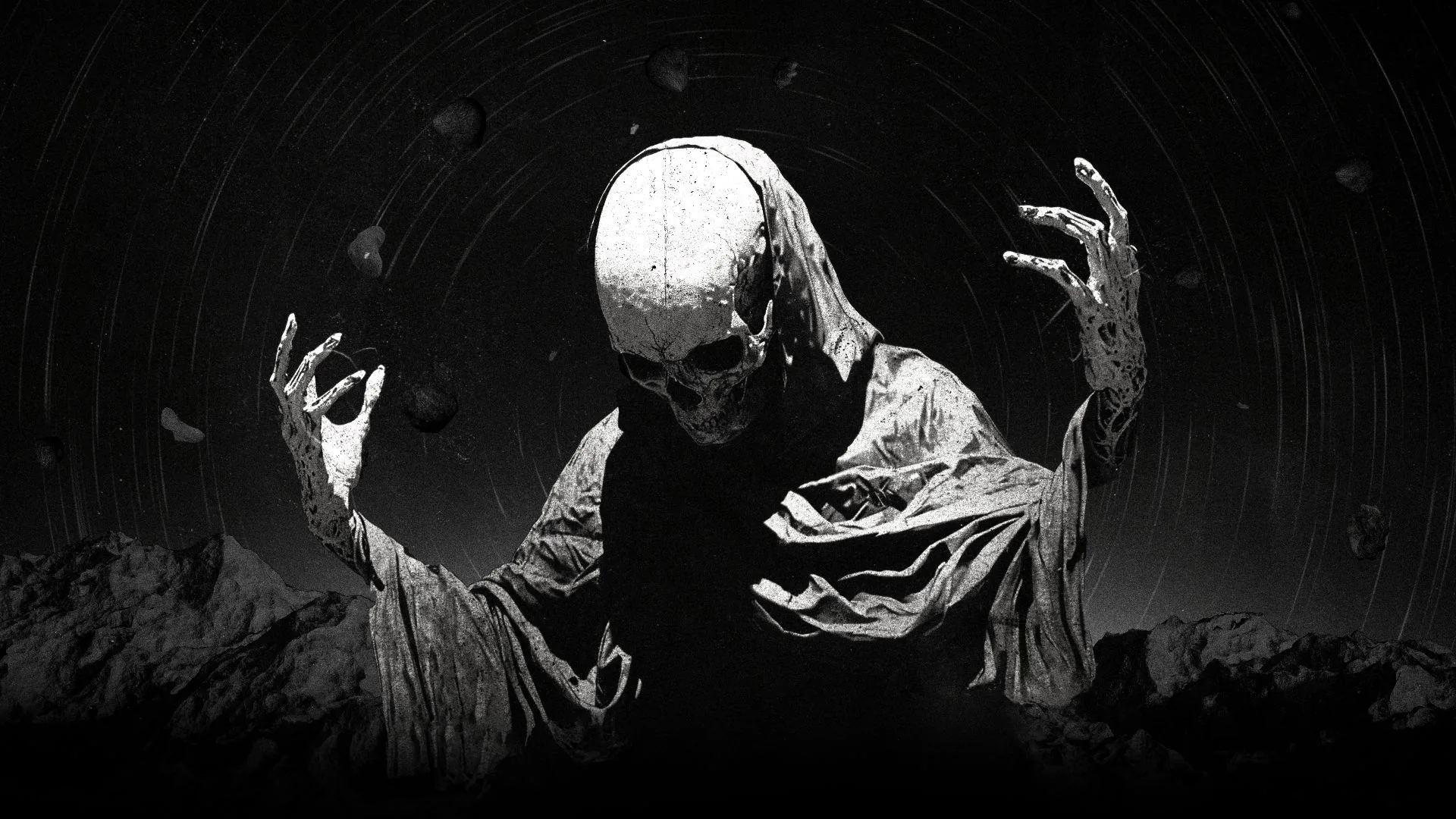 A gaunt figure in a shroud lifts both hands toward the camera, lit hard from the front against black.