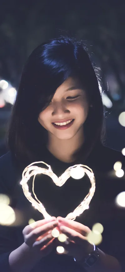 Girl Holding a Heart of Fairy Lights HD Phone Wallpaper