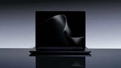 Matte Black Laptop on a Glossy Desk HD Wallpaper