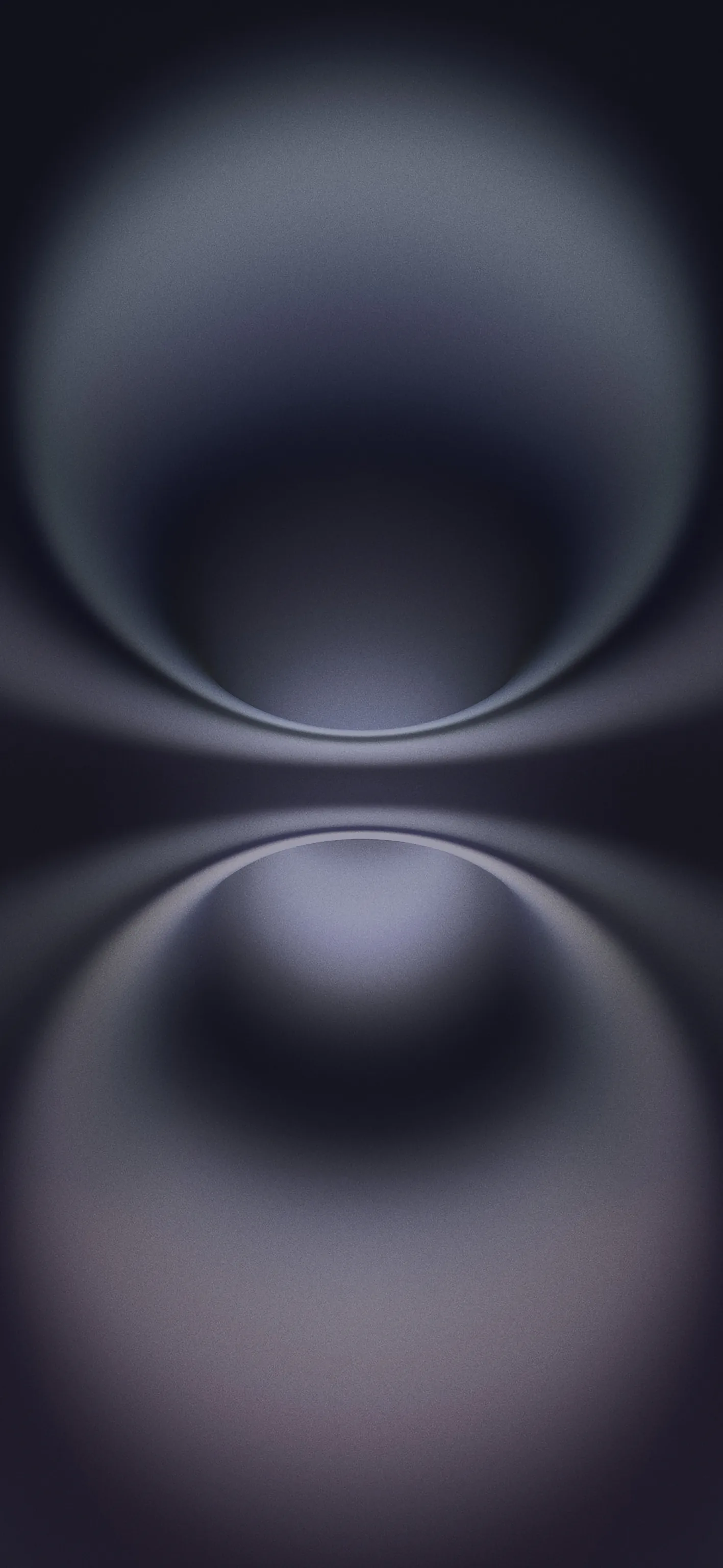 Two glossy grey-lilac spheres meet at the middle of the frame in mirror image, their soft blur fading to black at every side.