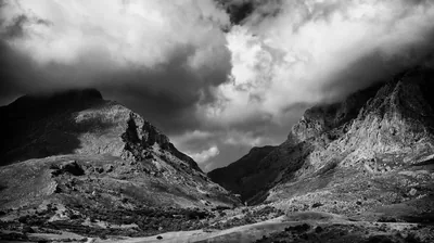 Storm Clouds Over a Rocky Mountain Pass HD Wallpaper