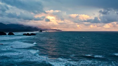 Teal Swell Along a Rugged Coast HD Wallpaper