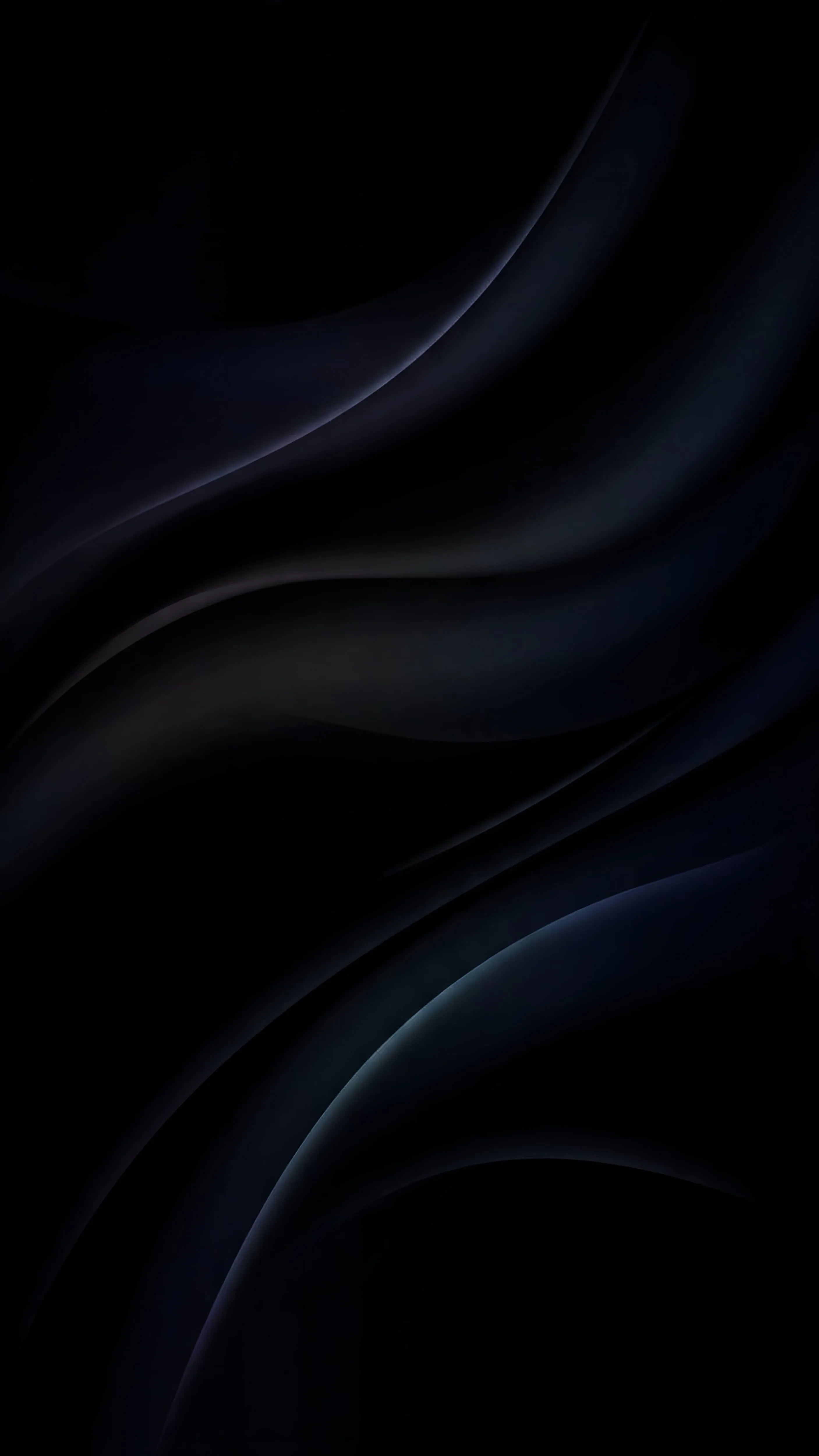 Heavy folds of near-black silk run diagonally, a cold blue sheen picking out two ridges near the lower right corner.