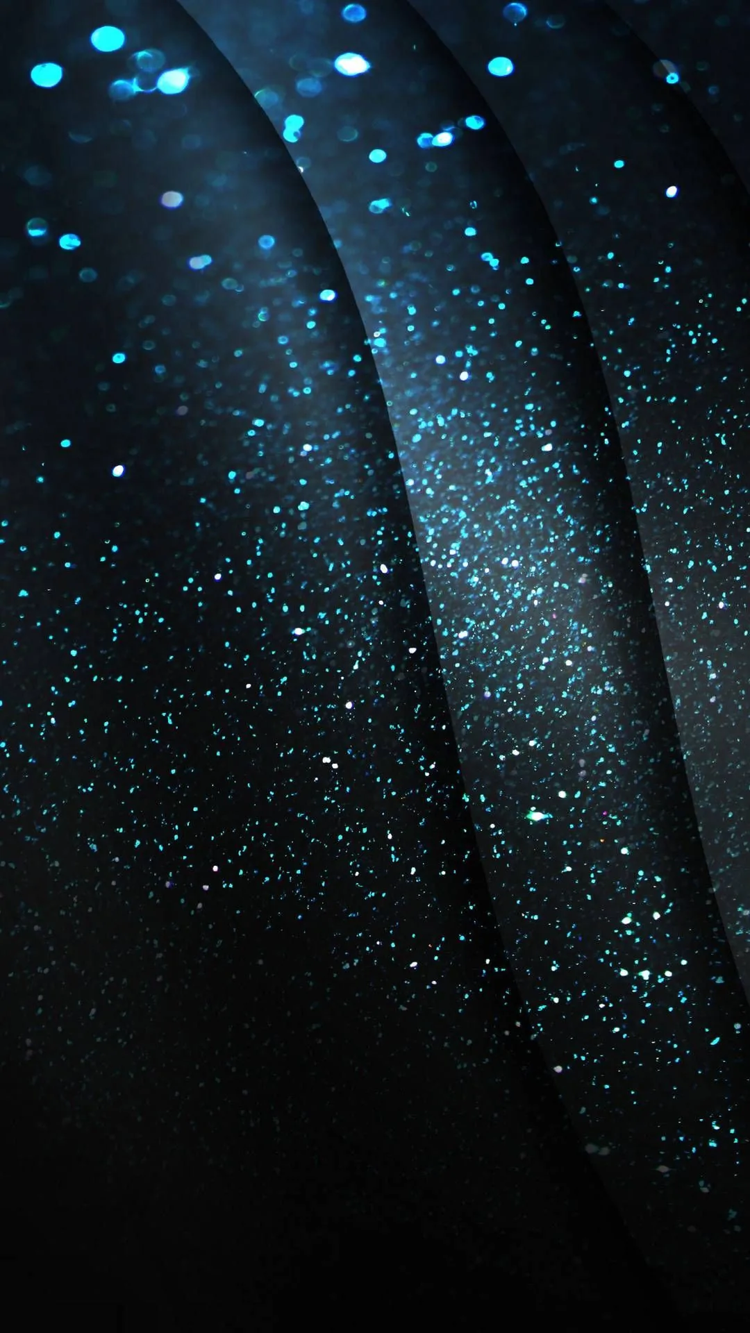 Specks of blue glitter scatter across diagonal folds of near-black fabric, densest along the left seam while the lower-right corner stays plain dark.