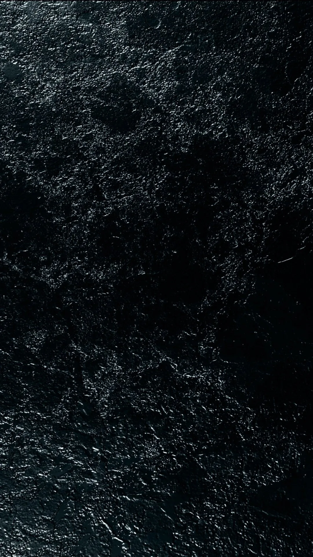Pale veins fracture across polished black stone, brightest along the upper edge and fading into shadow lower down.