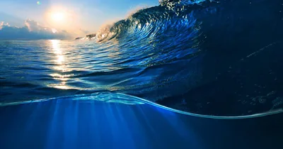 Cresting Wave with Underwater Light Rays HD Wallpaper