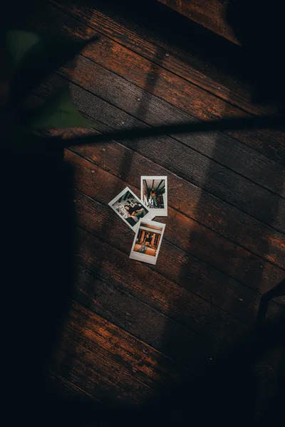 A photo of a polaroid on a wooden floor Free Stock Photo