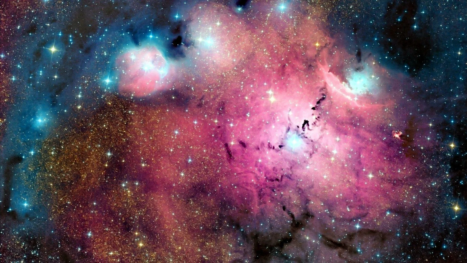 Rose-coloured gas fills most of the frame, cut by black dust lanes, with tight groups of blue-white stars burning at the top corners.