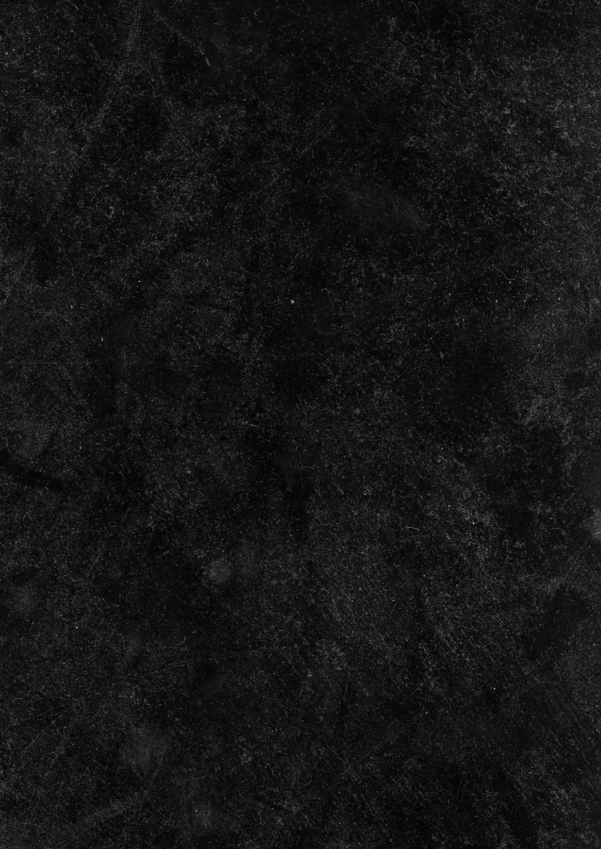 A mottled charcoal surface with faint scratches and cloudy patches, slightly lighter through the middle band and closing back into black at both ends.