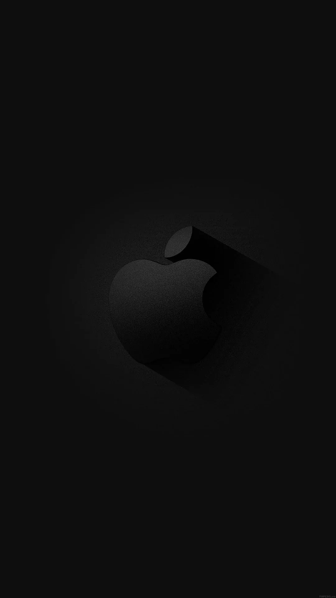 The Apple mark sits raised on a black panel, a soft ring of light behind it and the corners dropping away to nothing.