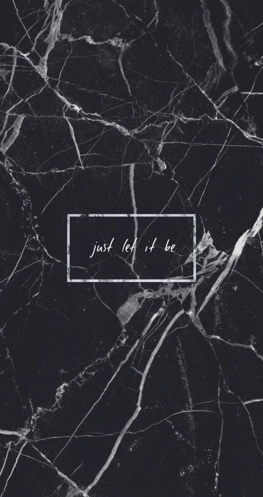 Pale veins run through polished black marble, a small handwritten line boxed off at the centre of the frame.