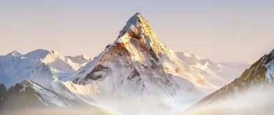 Sunlit Peak Rising Through Fog HD Wallpaper