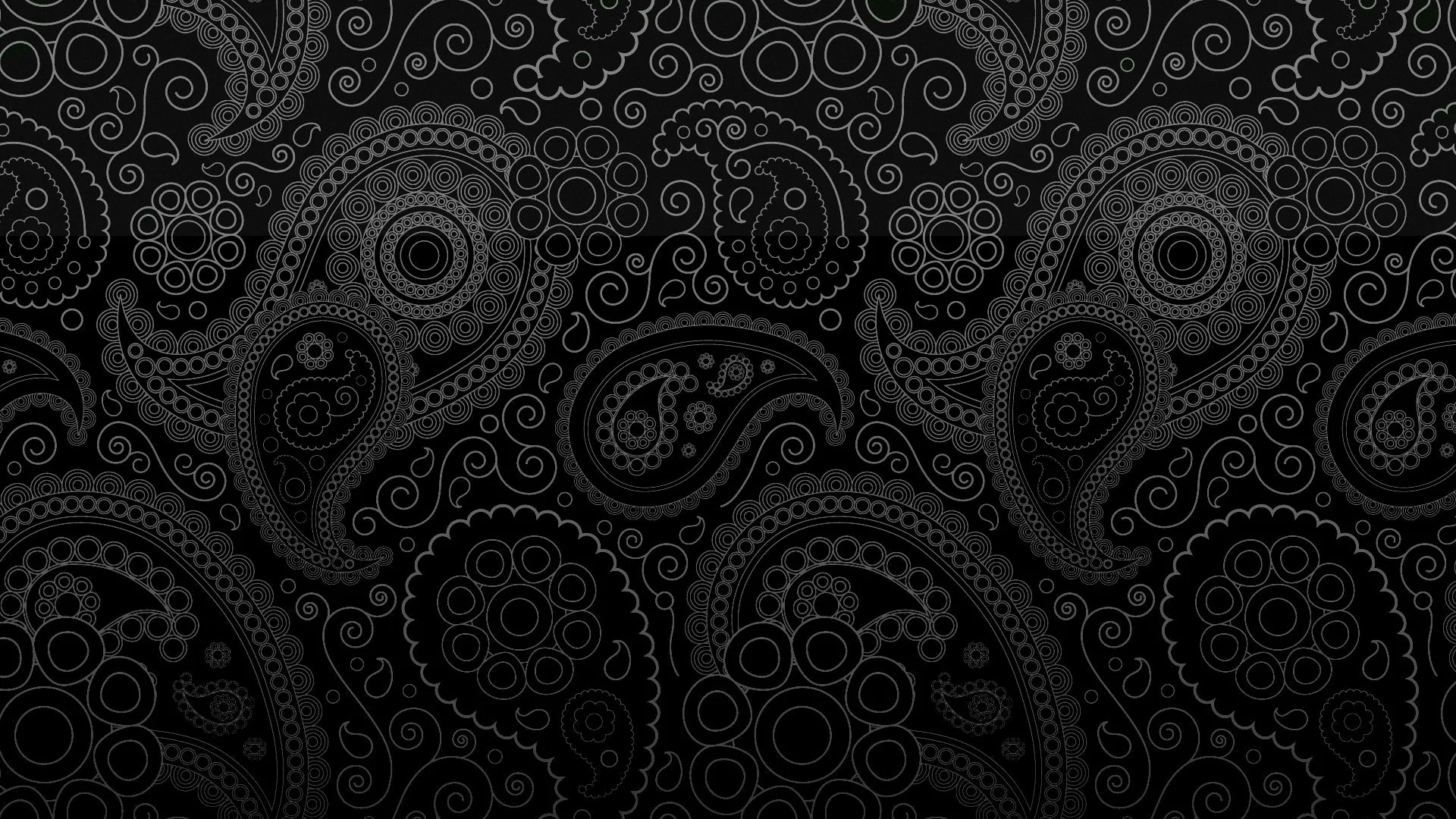 Paisley shapes and small medallions tile the whole frame in black on black, readable only by their raised edges.