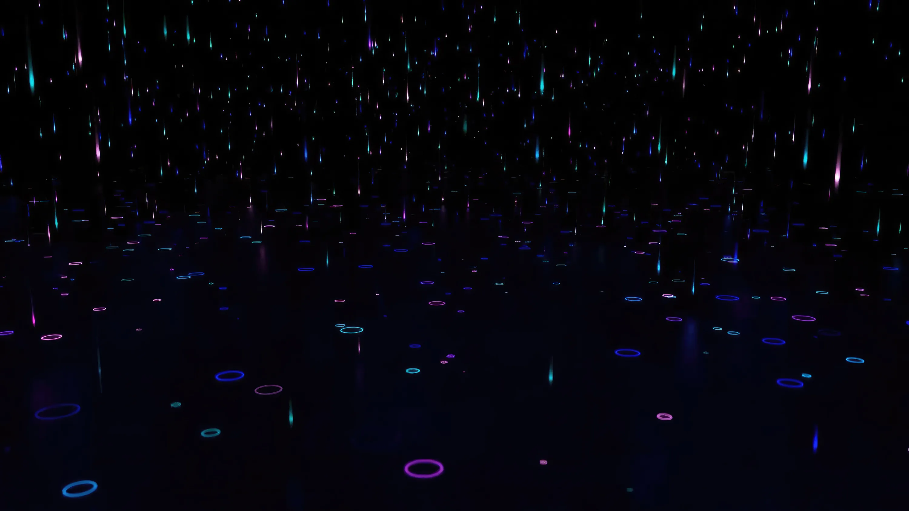 Thin streaks of light rain down onto a dark plane scattered with small pink and blue rings, most of the sky left black.