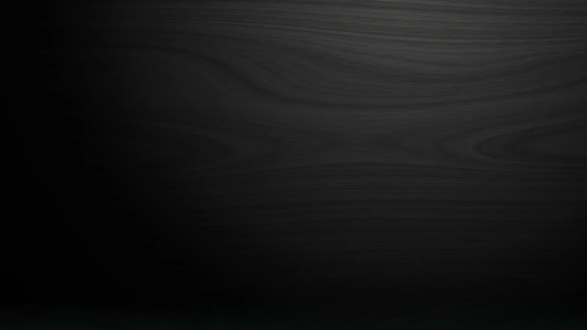 Faint horizontal wood grain runs across charcoal-black boards, a soft light falling from the top so the lower half stays almost solid black.