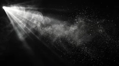 Abstract light rays and dust particles on a black background