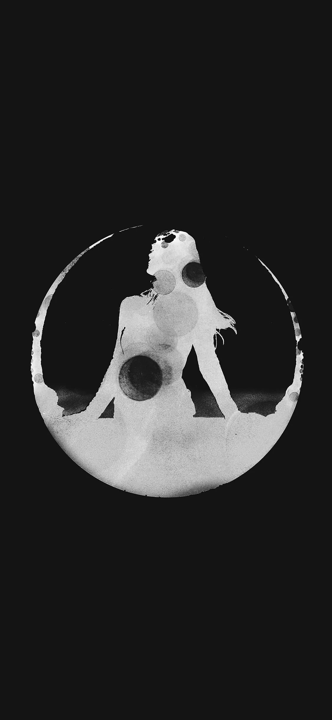 A negative-space design of a seated figure inside a brushed white crescent, centred on black; both top and bottom thirds are empty black for icons.