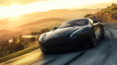 Aston Martin on a Sunlit Mountain Road HD Wallpaper