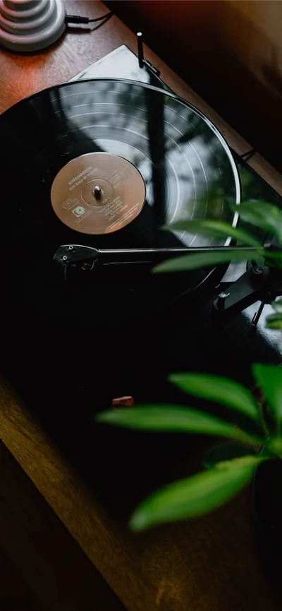 black turntable on brown wooden table iPhone Wallpapers