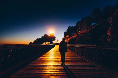 Silhouette on a Boardwalk at Sunset HD Wallpaper