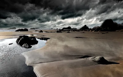Storm Clouds Over a Dark Beach HD Wallpaper