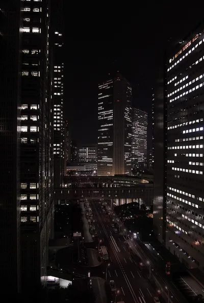 Office Towers Above a Night Highway HD Phone Wallpaper