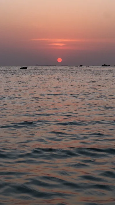 Pale Pink Sun Over a Calm Sea HD Phone Wallpaper