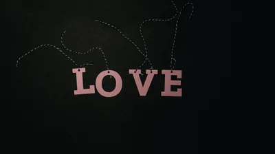 Pink Love Letters on a Dark Wall HD Wallpaper