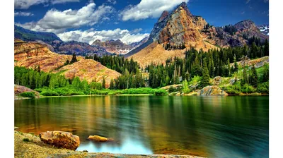 Rust-Banded Peak Over a Calm Lake HD Wallpaper