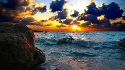 Sunstar Over a Rocky Cove HD Wallpaper