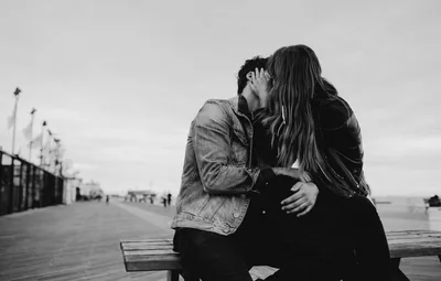 Couple Kissing on a Boardwalk Bench HD Wallpaper