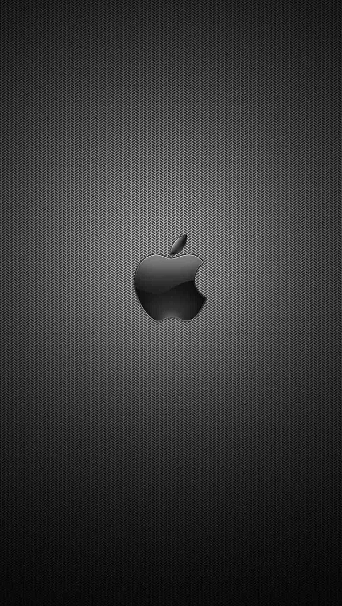 A fine woven grey mesh fills the screen, lit brightest at the centre where the Apple logo sits, with the corners falling to near black.