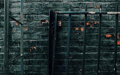 Green Brick Wall Behind Metal Railing HD Wallpaper