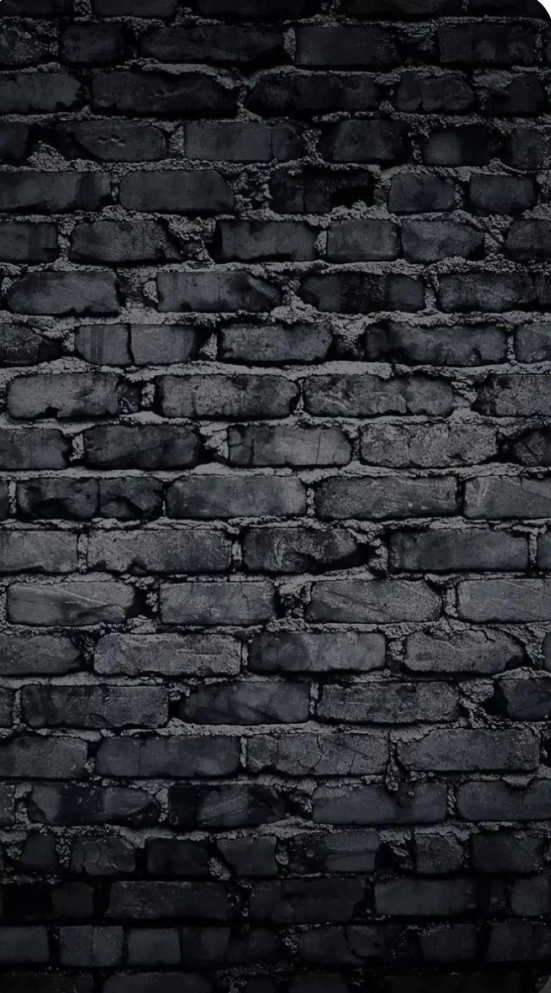 Old brick chipped at nearly every corner, a cool blue cast over the middle of the frame and heavy shadow closing in on both edges.