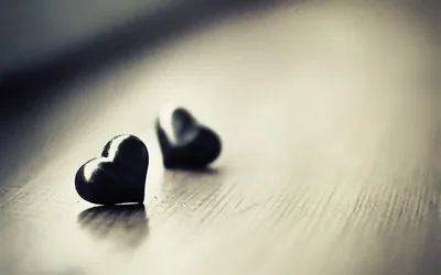Two Dark Hearts on a Wooden Table HD Wallpaper