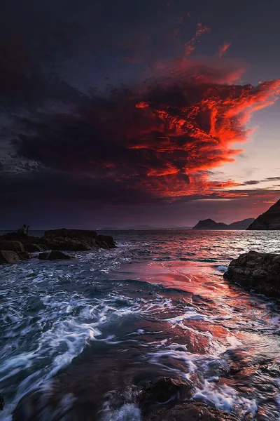 Red Storm Cloud Over a Rocky Coast HD Phone Wallpaper