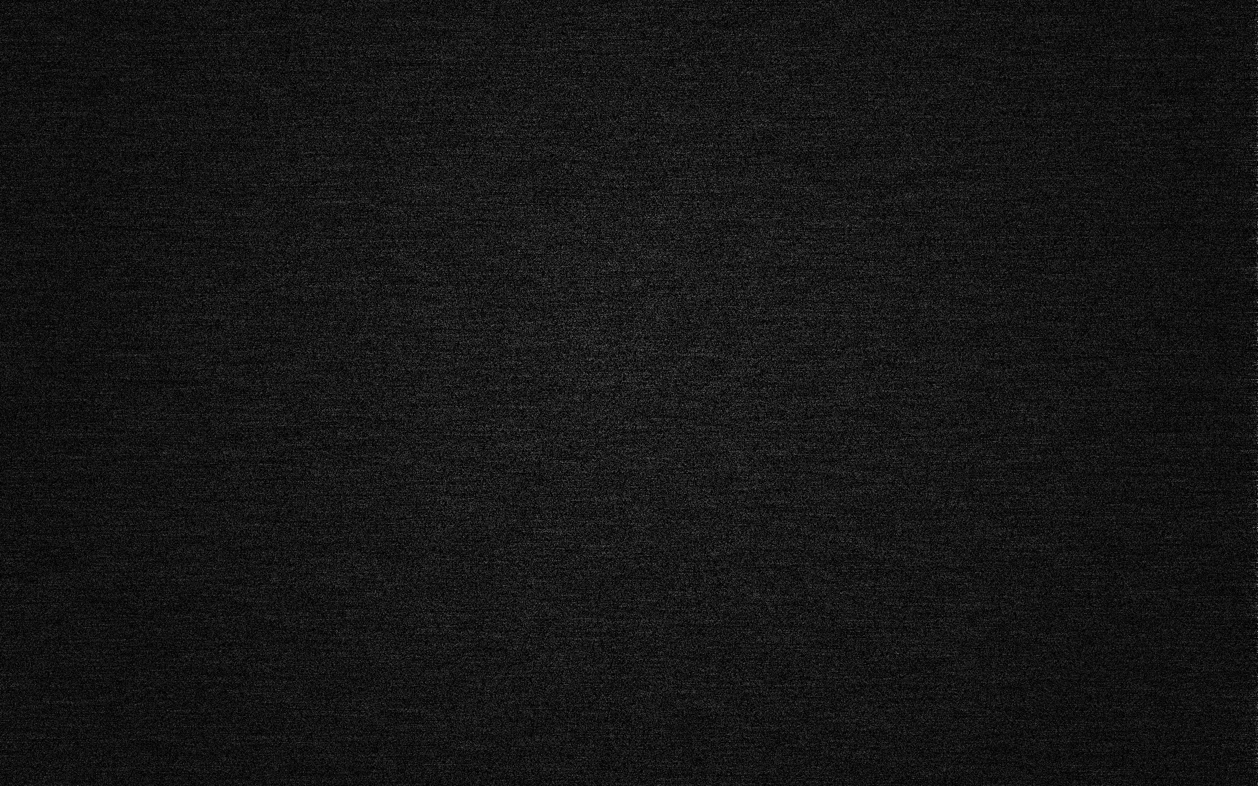 Tight woven denim in near-black, the diagonal thread showing only as fine grain, evenly lit corner to corner.
