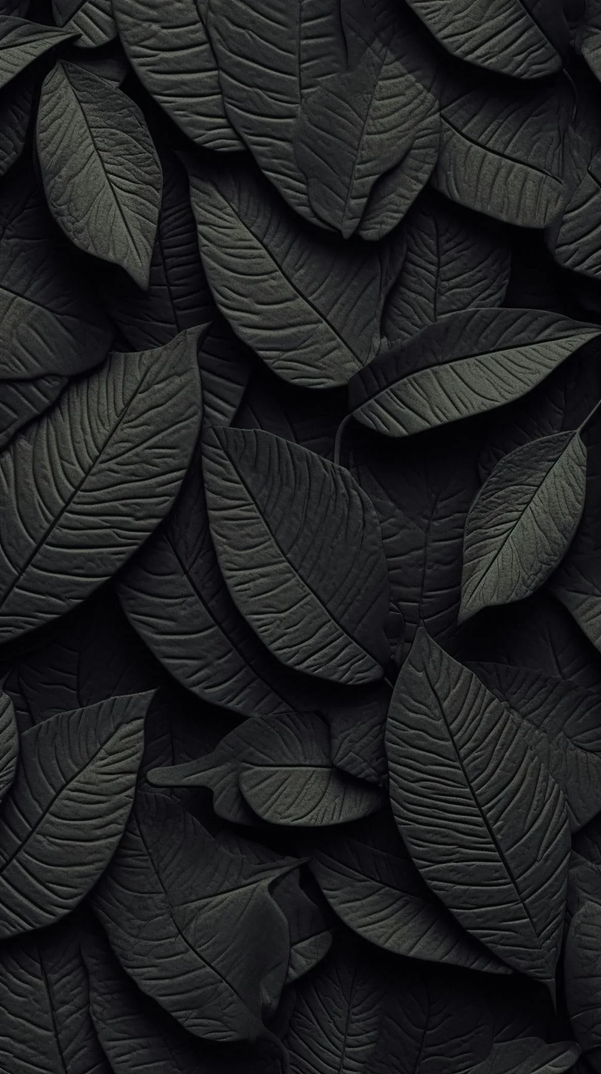Overlapping leaves moulded in matte black fill the frame, side lighting picking out every vein and raised edge.