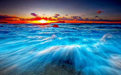Silky Blue Waves Under a Red Sunset HD Wallpaper
