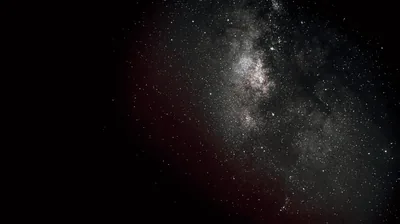 Dim Galactic Core With a Red Glow HD Wallpaper