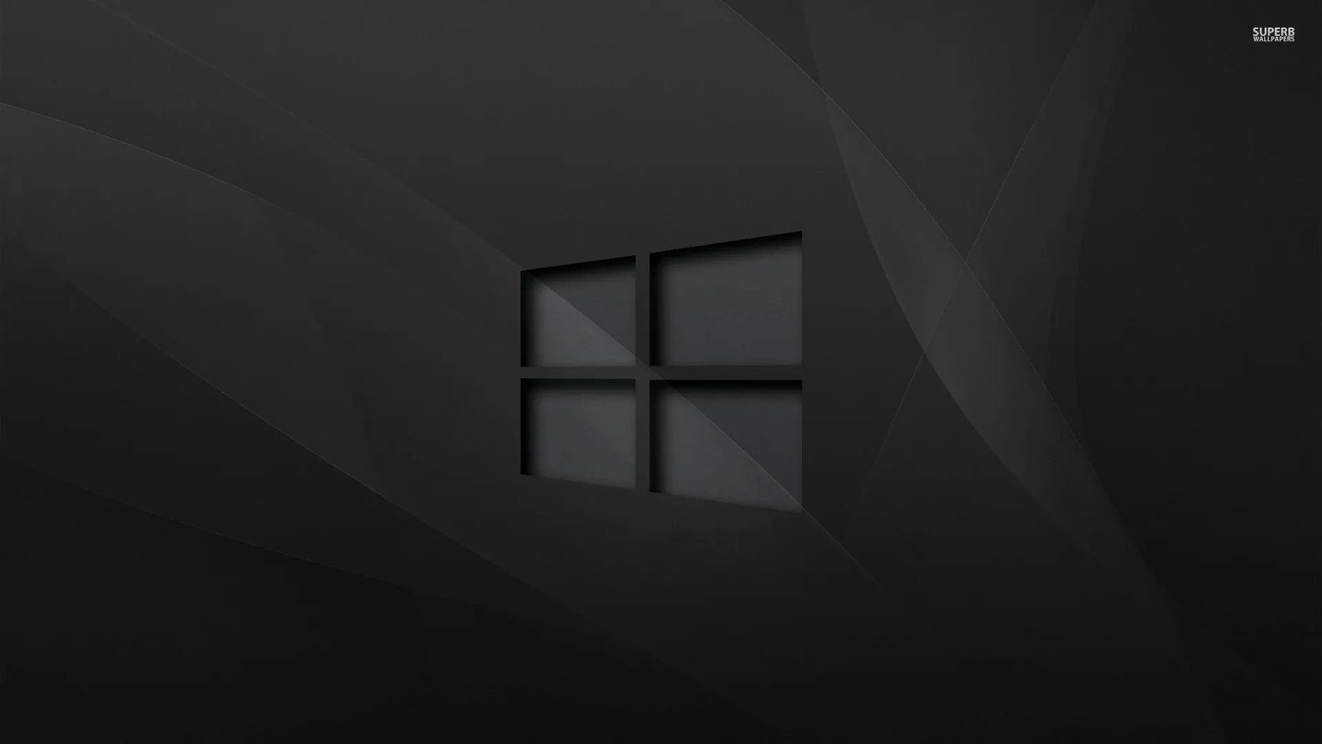The Windows outline etched into a slate grey background with soft diagonal folds running behind it like brushed cloth.