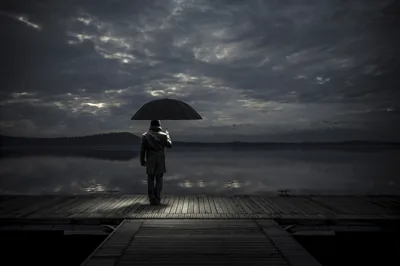 Man With an Umbrella on a Dock HD Wallpaper