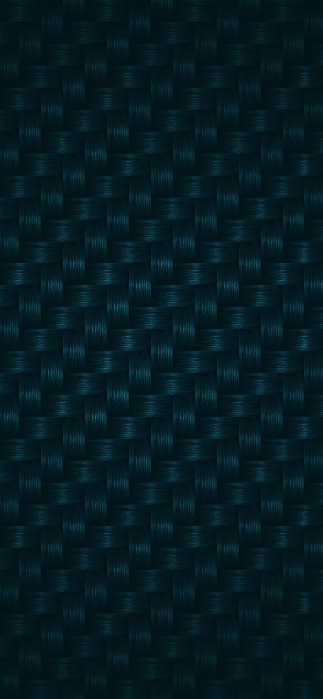 A tight basket weave of carbon fibre in near-black teal, the sheen shifting slightly from one row of the weave to the next.