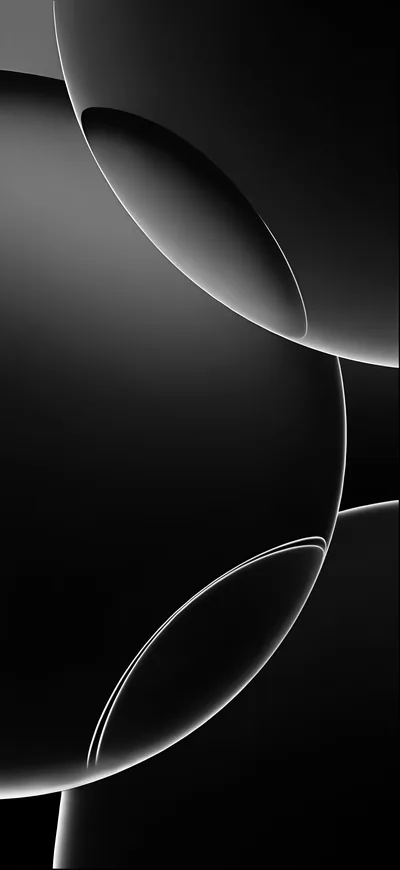 Two large glossy spheres cross in a tall frame, thin white rims tracing where their edges meet against the black.